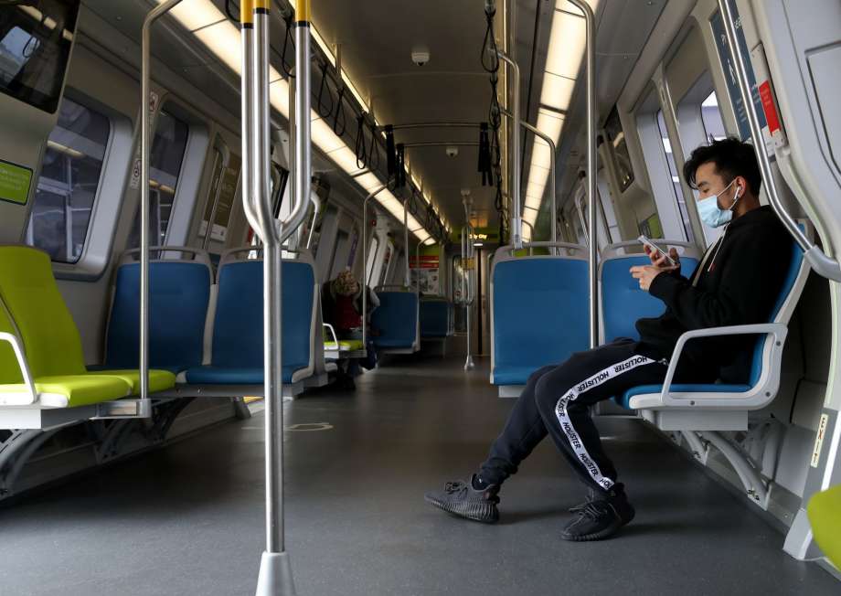 A Bay Area Rapid Transit (BART) passenger wears a protective mask while riding on a train on April 08, 2020 in San Francisco, California. BART announced that it is slashing daily service as ridership falls dramatically due to the coronavirus shelter in place order. Starting Wednesday, regular Monday through Friday service will be reduced to running trains every half hour between 5 am and 9 pm. Photo: Justin Sullivan/Getty Images / 2020 Getty Images
