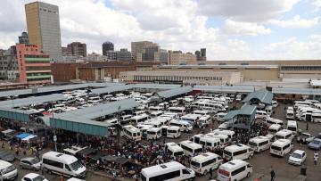 Passengers are seen at taxi rank just before Johannesburg locked down to stop the spread of coronavirus on March 25.