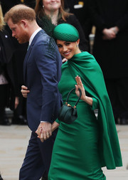 Meghan Markle matched her dress and purse with a green William Chambers hat for the 2020 Commonwealth Day Service.