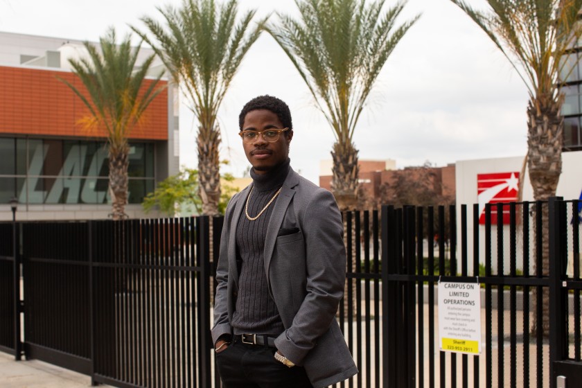 Stevie Carpenter, a graduate of Los Angeles City College, stands in front of the closed campus