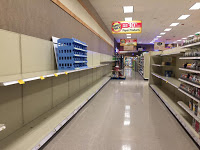 Empty shelves where toilet paper and other paper products should be
