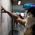 Commuters wearing handkerchiefs as masks look at a metro train map at a station, amid coronavirus disease (COVID-19) fears, in New Delhi, India, March 13, 2020. REUTERS/Danish Siddiqui
