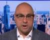 Ali Velshi wearing glasses and smiling at the camera