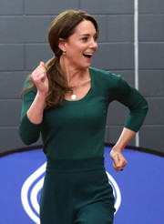 Kate Middleton matched a ribbed green scoopneck sweater by Mango with a pair of wide-leg pants for a SportsAid Stars event.