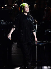 Billie Eilish performed at the 2020 BRIT Awards wearing an oversized black mesh polo shirt and matching pants.