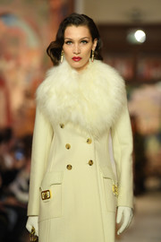 Bella Hadid was winter-glam in her white leather gloves and coat combo while walking the Lanvin runway.