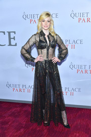Katherine McNamara looked sassy in a sheer black and gold shirtdress layered over cigarette pants at the world premiere of 'A Quiet Place Part II.'