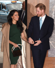 Meghan Markle attended the WellChild Awards carrying a scarf-handle bag by Montunas.