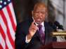 John Lewis wearing a suit and tie: Congress honors Lewis with moment of silence