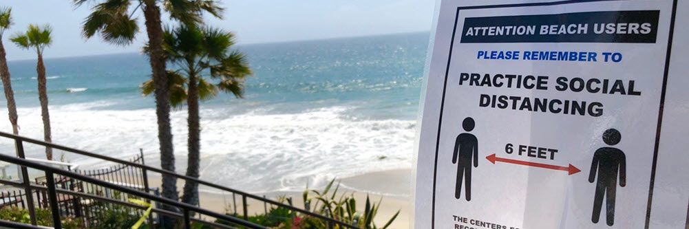 a flyer encouraging social distancing by the beach