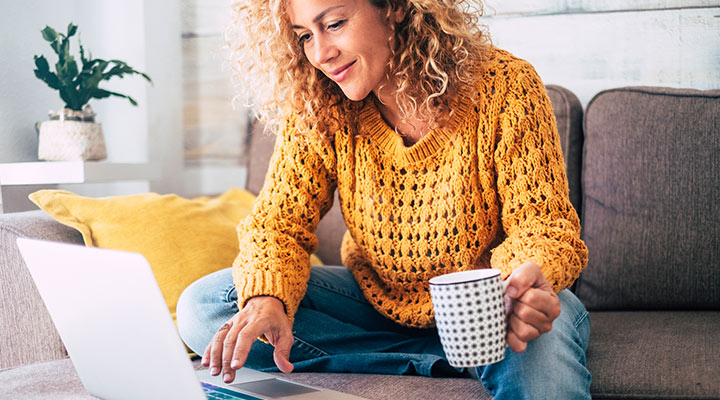 woman at home on computer with coffee