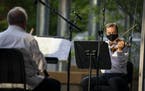 Peter McGuire, on the violin, played Mozart's "Quartet for Oboe, Violin, Viola, and Cello in F major" during an outdoor Minnesota Orchestra concert in