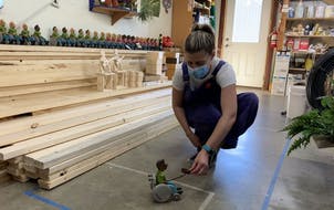 Miranda Gray-Burlingame test-drives one of the newest handmade wooden toys at Lark Toys in Kellogg, Minn. Her family-owned shop is one of many Minneso