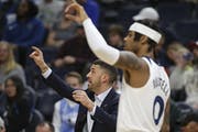 Timberwolves' head coach Ryan Saunders signals to his team alongside ' D'Angelo Russell during a game against the Dallas Mavericks.