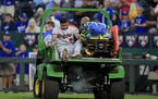 Twins third baseman Luis Arraez is taken from the game after an injury during the seventh inning
