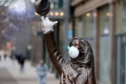 The Mary Tyler Moore statue on Nicollet Mall got a mask and rubber glove, perhaps for levity in the face of the Coronavirus, and seen Wednesday, April