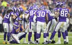 Minnesota Vikings' quarterback Kirk Cousins called plays in the huddle in the first quarter.