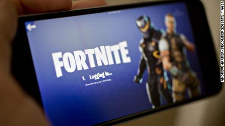 The Epic Games Inc. Fortnite: Battle Royale video game is displayed for a photograph on an Apple Inc. iPhone in Washington, D.C., U.S., on Thursday, May 10, 2018. Fortnite, the hit game that&#39;s denting the stock prices of video-game makers after signing up 45 million players, didn&#39;t really take off until it became free and a free-for-all. Photographer: Andrew Harrer/Bloomberg via Getty Images