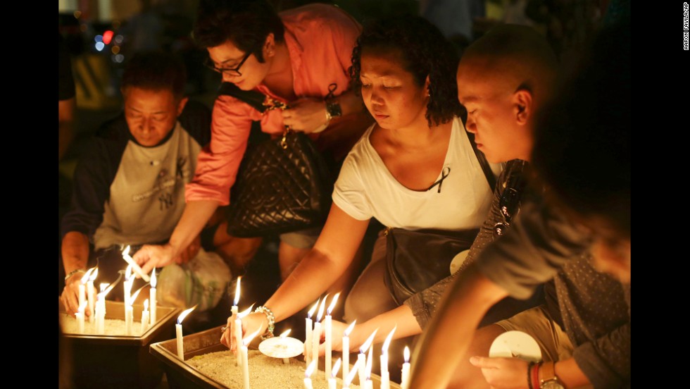 People in Kuala Lumpur light candles during a ceremony held for the missing flight&#39;s passengers on March 27, 2014.