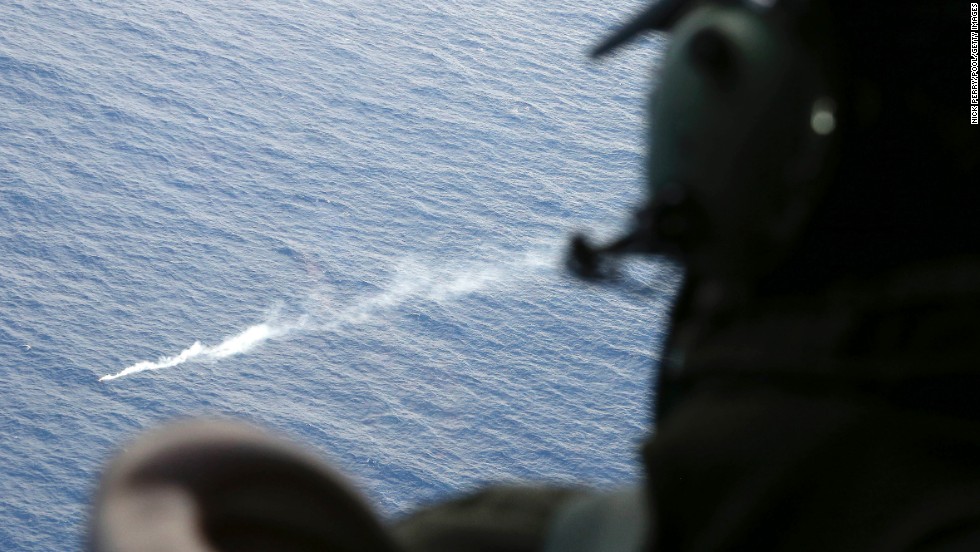 A member of the Royal New Zealand Air Force looks at a flare in the Indian Ocean during search operations on April 4, 2014.