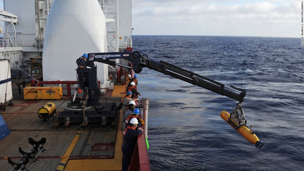 Operators aboard the Australian ship Ocean Shield move Bluefin-21, the U.S. Navy&#39;s autonomous underwater vehicle, into position to search for the jet on April 14, 2014.
