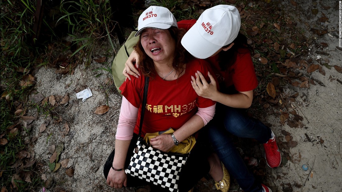 Relatives of the flight&#39;s passengers console each other outside the Malaysia Airlines office in Subang, Malaysia, on February 12, 2015. Protesters had demanded that the airline withdraw the statement that all 239 people aboard the plane were dead.