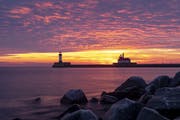 The first sunrise of 2020 brought deep orange and pink colors over the Duluth Harbor North and South Breakwater Lighthouses in Duluth
