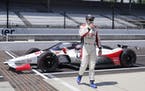 Marco Andretti walks away from his car after posing for a photo during qualifications for the Indianapolis 500