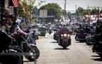 People ride through downtown Sturgis, S.D., during the 80th annual Sturgis Motorcycle Rally on Monday, Aug. 10, 2020.