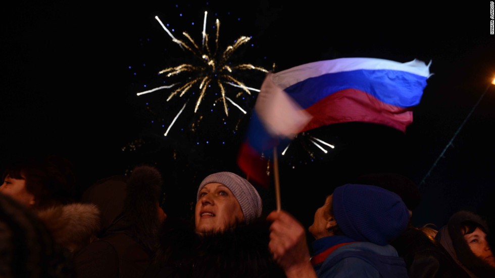 Crimeans holding Russian flags celebrate in front of the parliament building in Simferopol on Sunday, March 16.