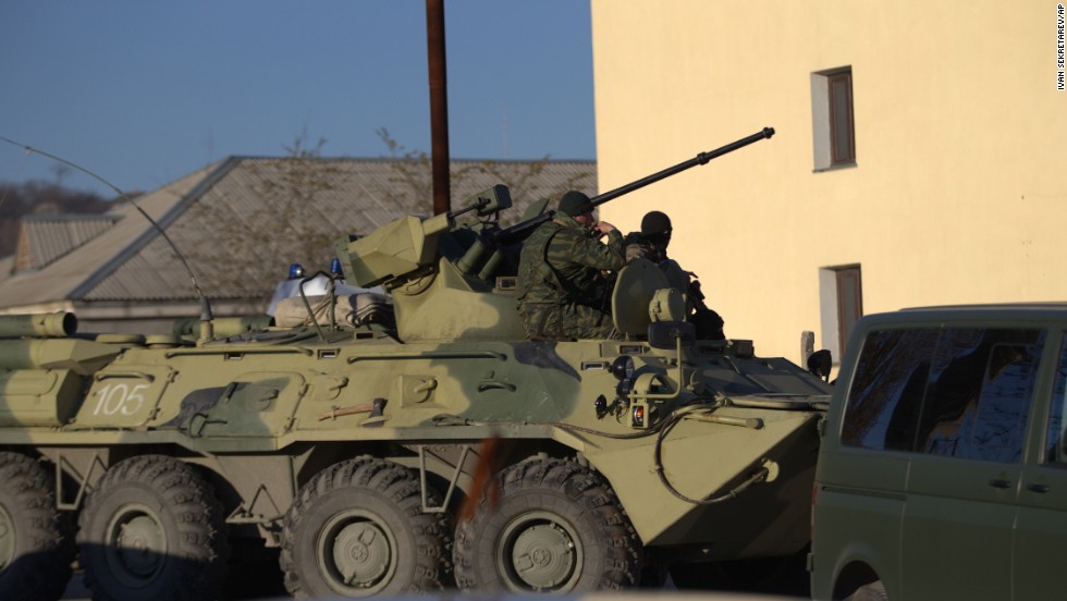 Soldiers in unmarked uniforms sit atop an armored personnel carrier at the gate of the Belbek air base on March 22. 