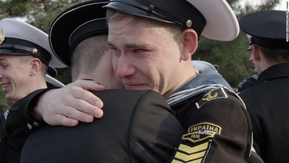 Ukrainian cadets at the Higher Naval School embrace a friend who has decided to stay in the school during a departure ceremony in Sevastopol, Crimea, on Friday, April 4. Some 120 cadets who refused to take Russian citizenship left the school to return to Ukraine.