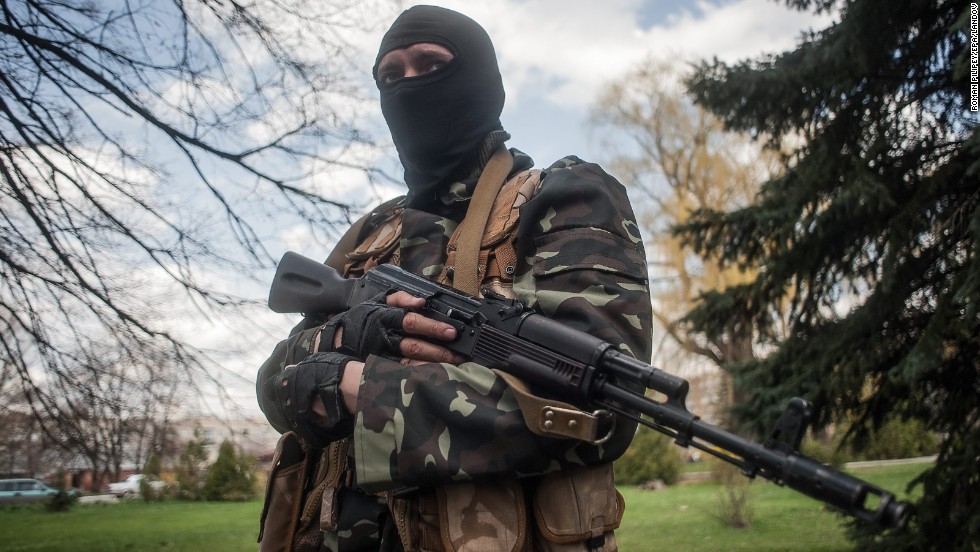 A masked gunman stands guard near tanks in Slovyansk on Wednesday, April 16. 