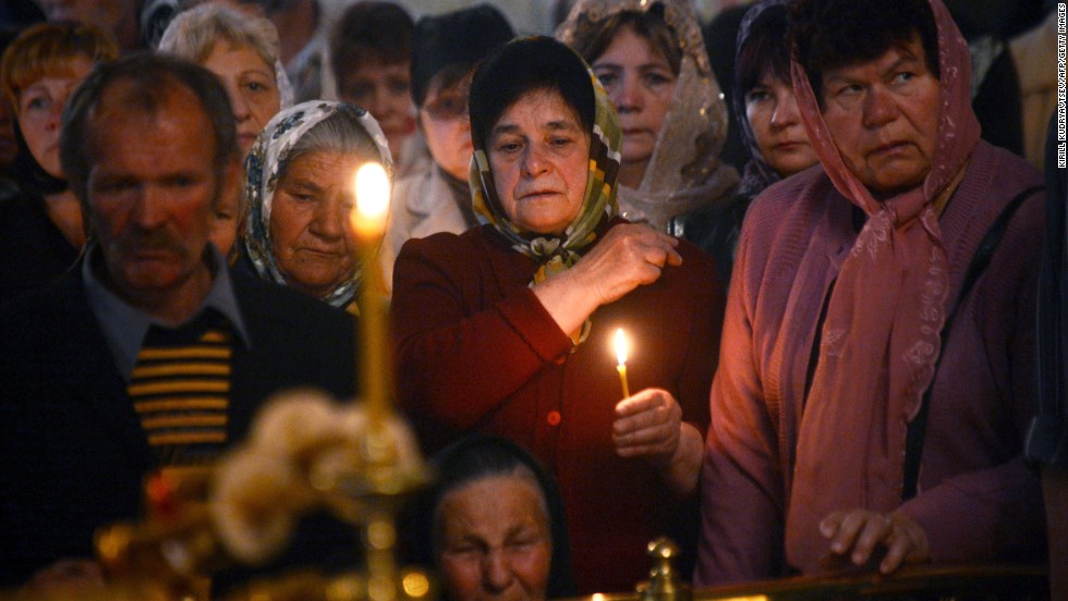 Relatives and friends of a man killed in a gunfight participate in his funeral ceremony in Slovyansk on Saturday, April 26.