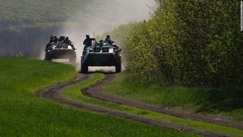 Ukrainian government troops in armored vehicles travel on a country road outside the town of Svyitohirsk in eastern Ukraine on April 26.