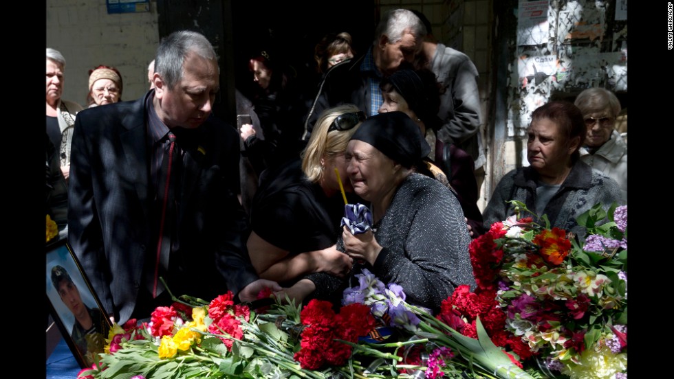 The mother of Dmitriy Nikityuk, who died in a fire at a trade union building during riots in Odessa, Ukraine, cries next to his coffin during his funeral on Thursday, May 8. 