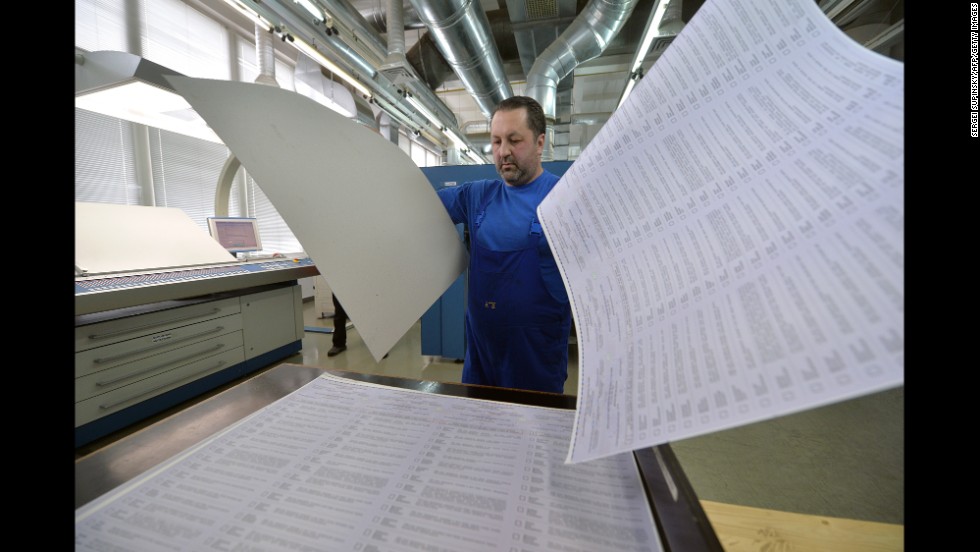A man examines ballots at a printing house in Kiev, Ukraine, on Wednesday, May 14. The ballots will be used in early presidential voting on May 25.