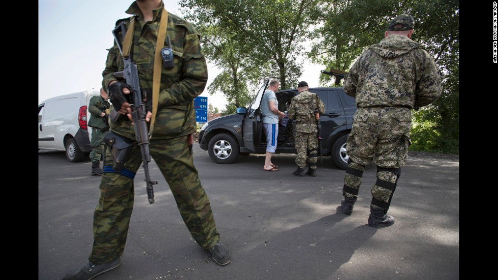 Pro-Russian armed militants guard a checkpoint in Slovyansk on May 19, blocking a major highway to Kharkiv.