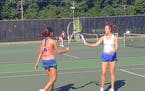 The racquet tap replaced high fives during Monday's tennis practice at Edina.
