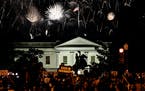 Protesters watch a fireworks display above the White House after President Donald Trump accepted the Republican presidential nomination during the fin