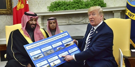 President Donald Trump (R) holds up a chart of military hardware sales as he meets with Crown Prince Mohammed bin Salman of the Kingdom of Saudi Arabia in the Oval Office at the White House on March 20, 2018 in Washington, D.C. Credit: Kevin Dietsch / Pool via CNP - NO WIRE SERVICE ' Photo by: Kevin Dietsch/picture-alliance/dpa/AP Images