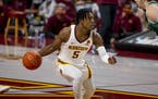 Minnesota guard Marcus Carr brings the ball up court against Green Bay in the first half of an NCAA college basketball game Wednesday, Nov. 25, 2020, 