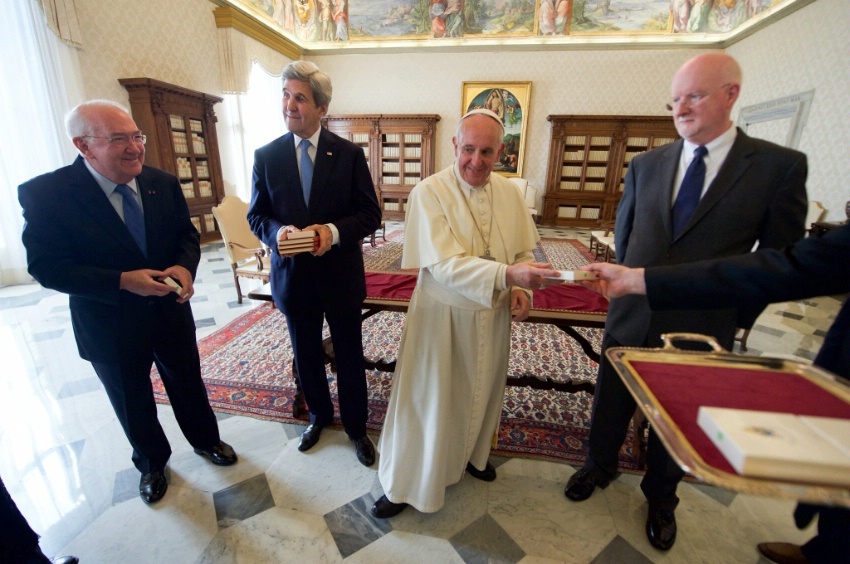 U.S. Ambassador to the Holy See Kenneth Hackett looks on as Pope Francis prepares to present him with a Papal medallion on December 2, 2016, following a one-on-one meeting with Secretary Kerry in the Papal Apartments at the Vatican in Vatican City. 