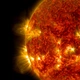The sun as a fiery red balls spewing particles