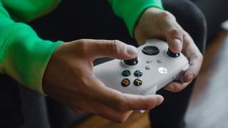A person's hands are shown holding the Robot White Xbox Wireless Controller.