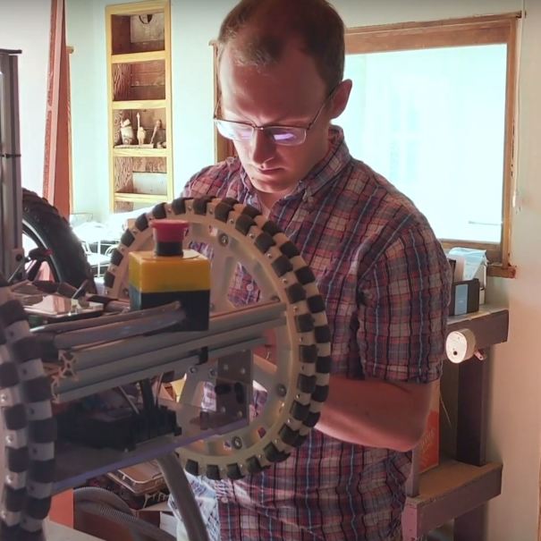 An Amazon employee works on a robotic drivetrain at his home, during COVID-19 pandemic.