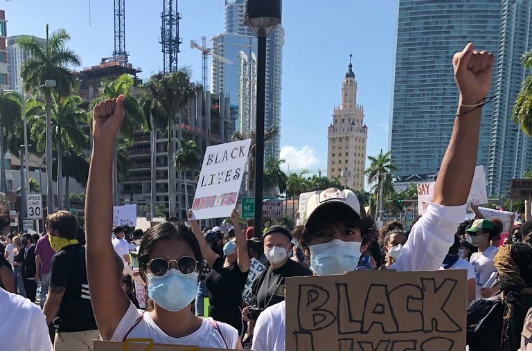 Teenagers at a Black Lives Matter demonstration in Miami in 2020. <a href="https://www.nytimes.com/2020/07/01/well/family/teenagers-anti-racism-parenting.html"