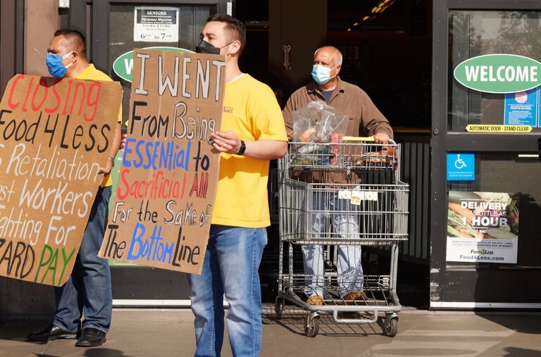 Workers protesting outside the Food 4 Less in Long Beach, Calif. Kroger plans to close the store after the city required “hero pay” for grocery workers.