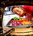 woman roasting vegetables in oven