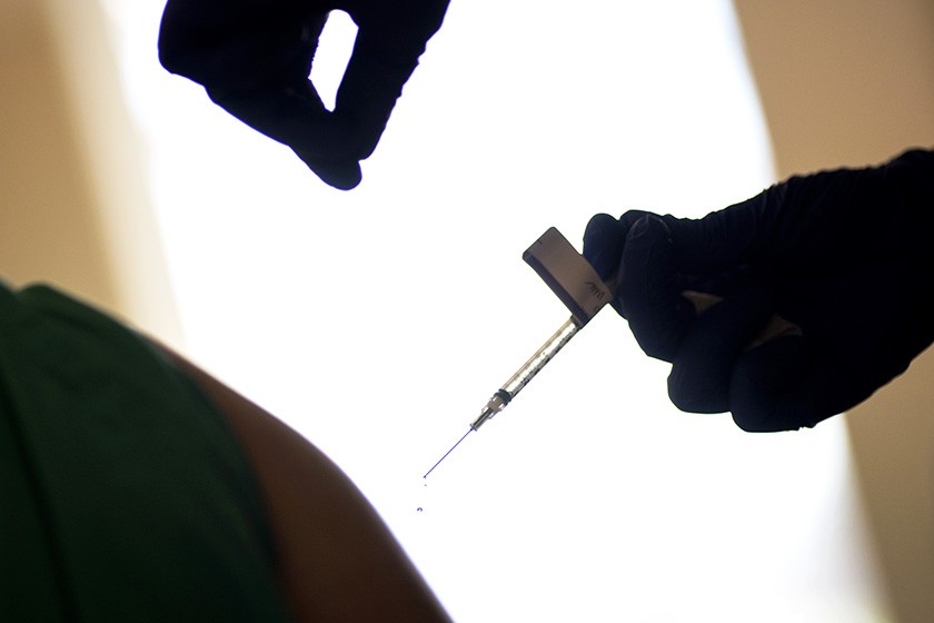 A person gets a vaccine shot.